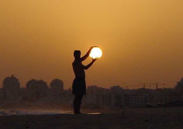 Man "holding" sun - photography photo